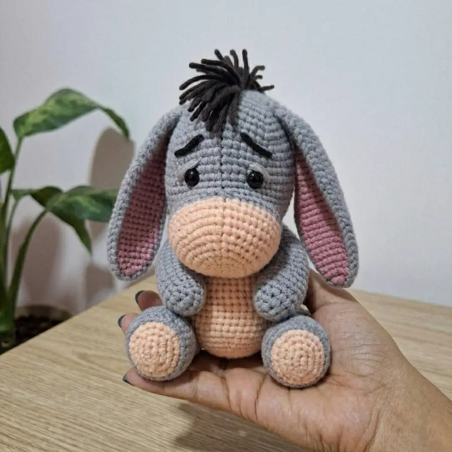 Finished Eeyore amigurumi held in hands